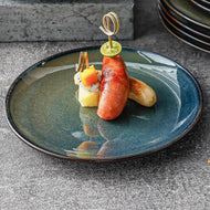 Kadum Speiseteller Ø 26 cm, angerichtet mit Fingerfood – elegante Präsentation.